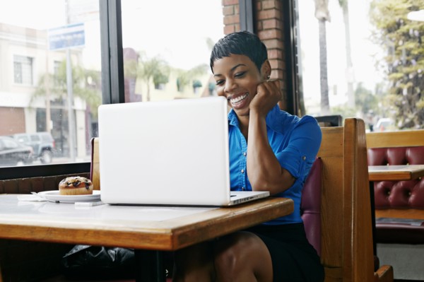 African American businesswoman using laptop in restaurant