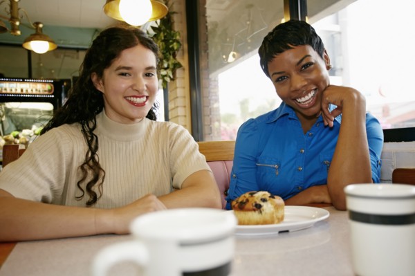 Women laughing in restaurant booth