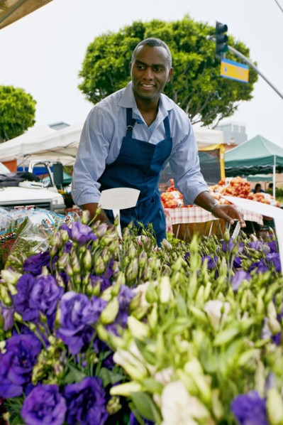 Black man working at outdoor market