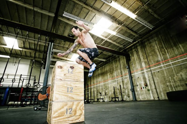 Mixed race man exercising in gym
