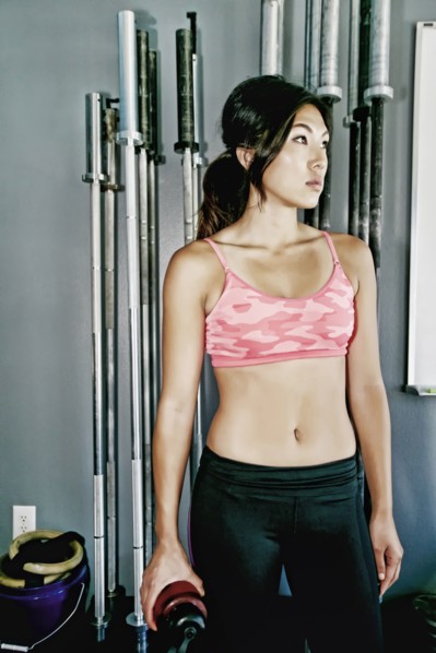 Asian woman working out in gym