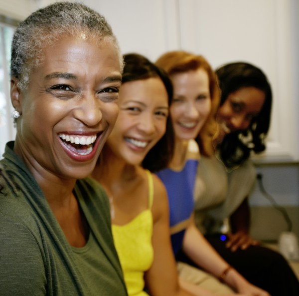 Women laughing together in kitchen