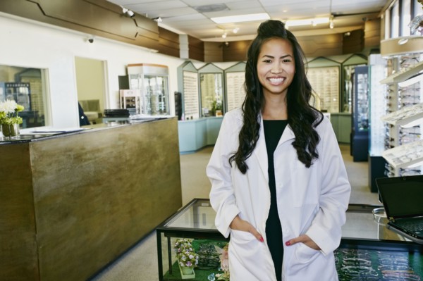 Vietnamese optometrist smiling in office