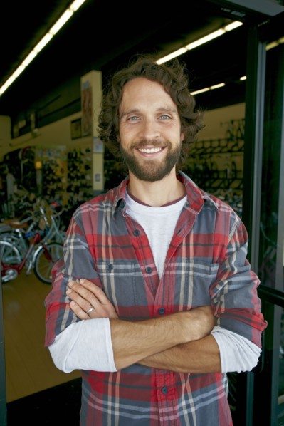 Caucasian man smiling in bicycle shop