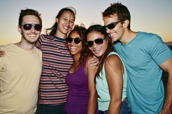 Friends smiling together on beach