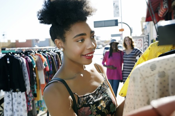 Mixed race woman shopping on city street