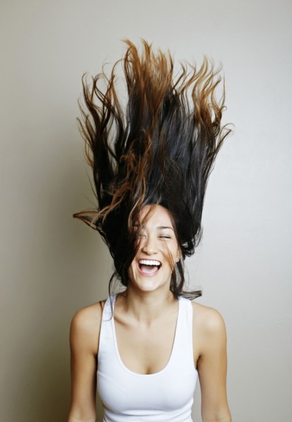 Mixed race woman tossing her hair
