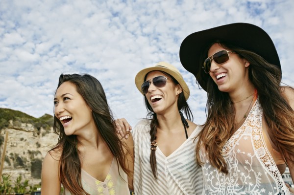 Women smiling together on beach