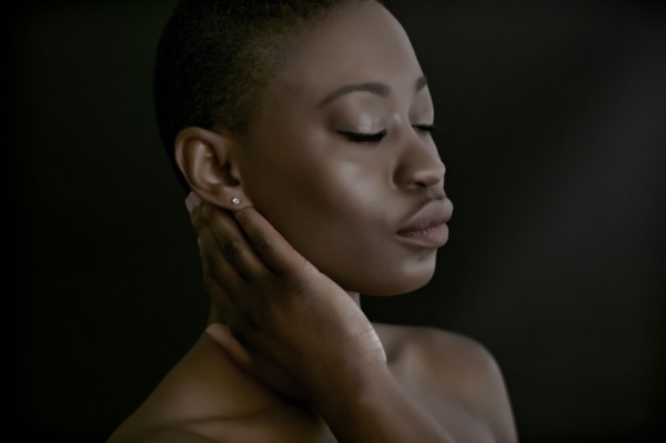 Black woman with hand on neck