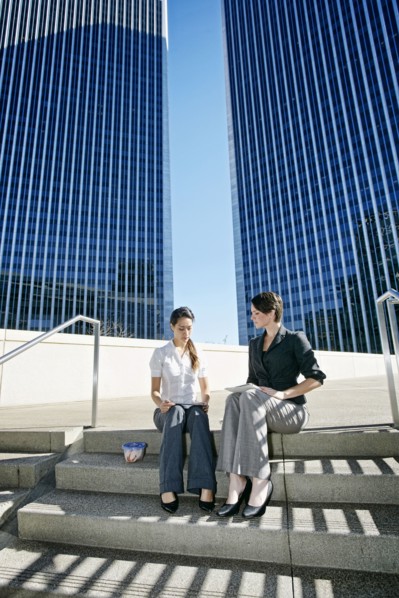 Businesswomen talking on city staircase
