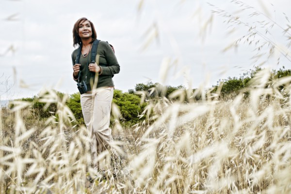 Black woman hiking on rural hillside