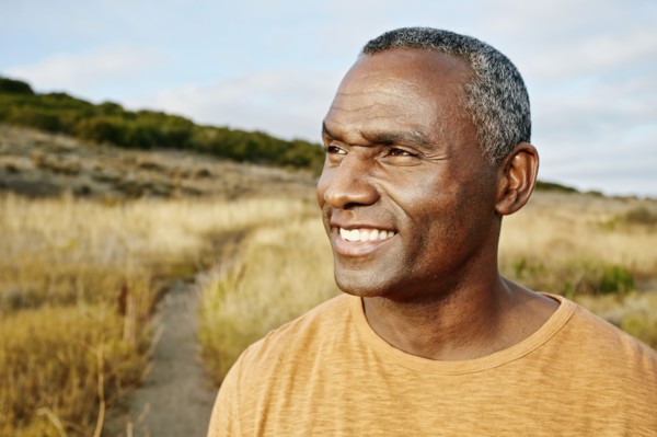 Black man standing on rural path