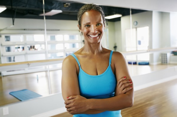 Black woman smiling in yoga studio
