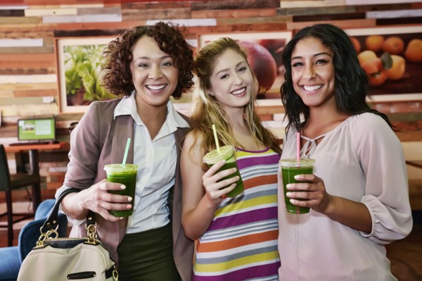 Women having juice together in cafe