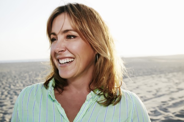 Caucasian woman smiling on beach