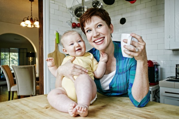 Caucasian mother and baby relaxing in kitchen