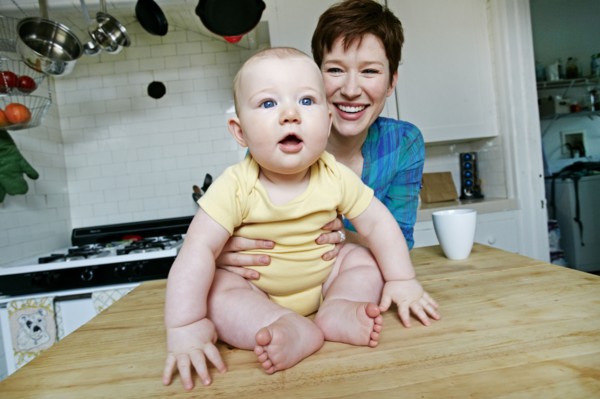 Caucasian mother and baby relaxing in kitchen