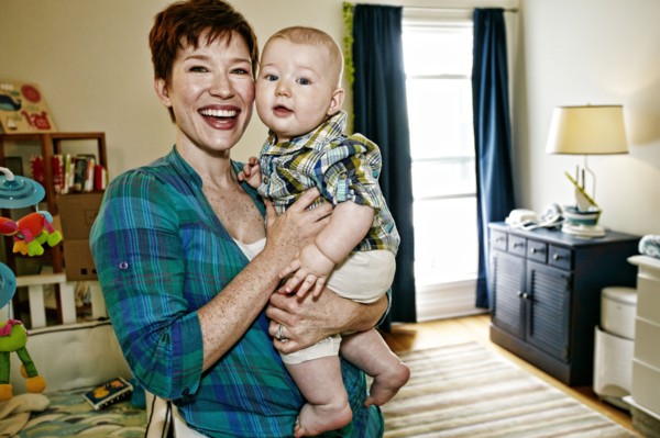 Caucasian mother holding baby in bedroom