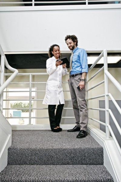 Doctor and businessman using digital tablet together