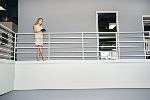 Caucasian businesswoman using digital tablet railing