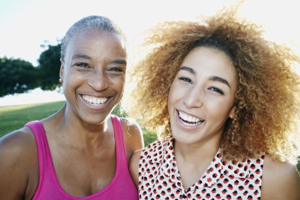 Mother and daughter smiling outdoors