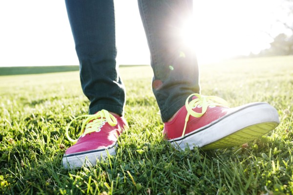 Close up of Hispanic woman's sneakers