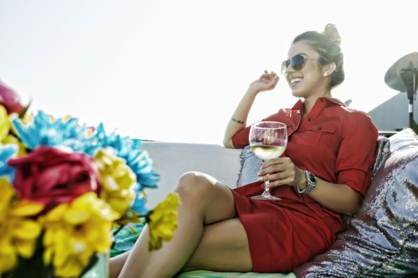Mixed race woman drinking white wine