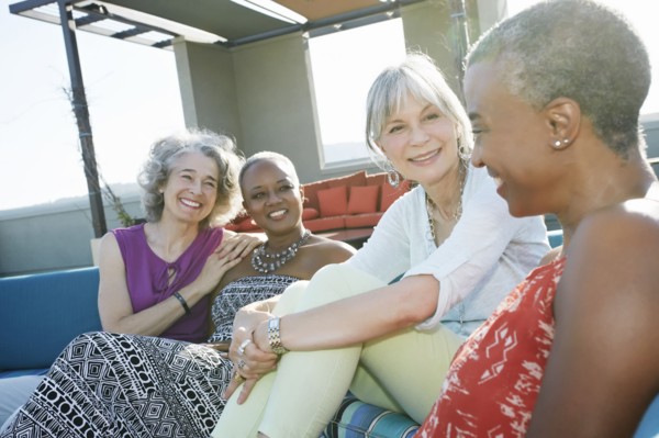 Women relaxing together on urban rooftop