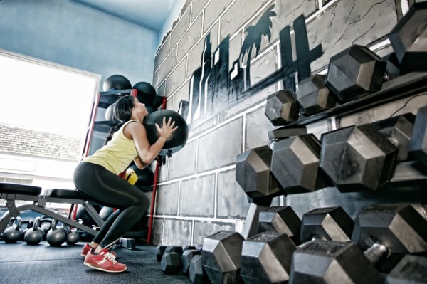 Hispanic woman exercising in gym