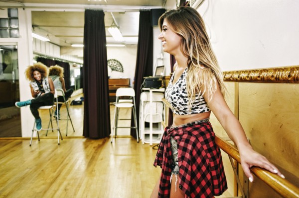 Dancer standing at bar in studio
