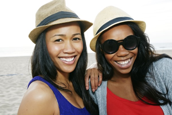 Close up of women smiling on beach