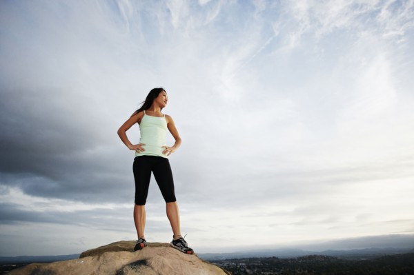 Vietnamese woman standing on rocky hilltop