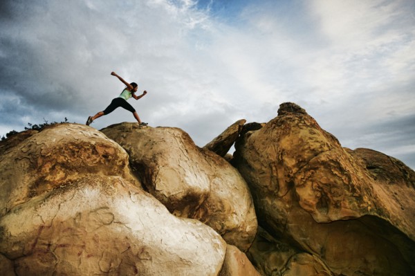 Vietnamese woman running on rocky hilltop