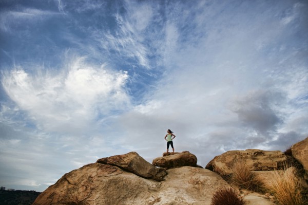Vietnamese woman standing on rocky hilltop