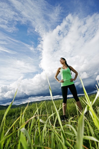 Mixed race athlete standing in rural field