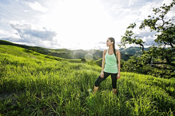 Mixed race athlete standing on rural hillside