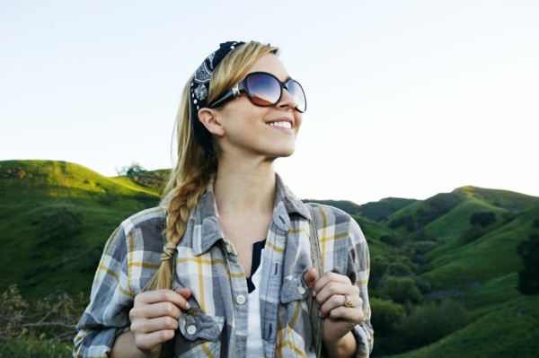 Caucasian woman smiling on rural hilltop