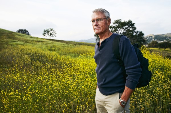 Caucasian man standing in tall grass