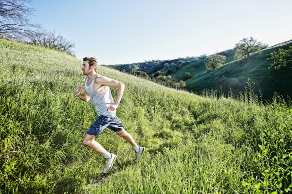 Caucasian athlete running on rural trail