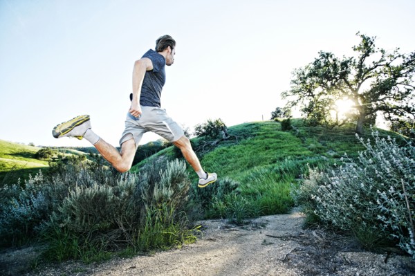 Caucasian athlete running on rural trail