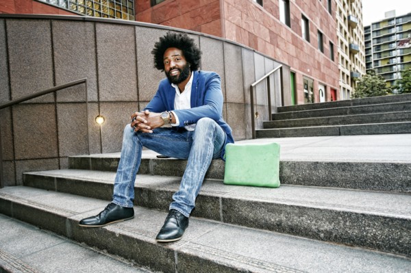 Mixed race businessman sitting on steps
