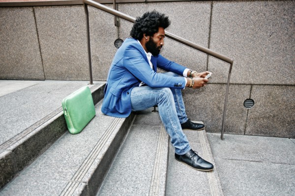 Mixed race businessman using cell phone