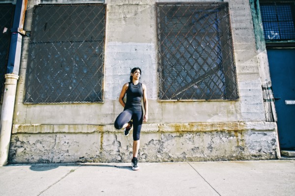 Mixed race woman leaning on wall