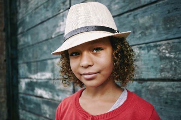 Mixed race girl wearing fedora