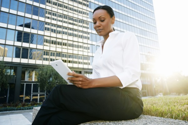 Black businesswoman using digital tablet outdoors