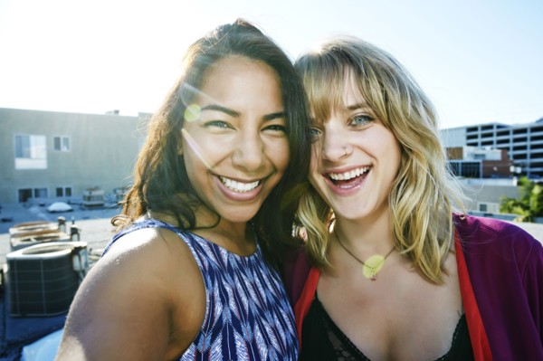 Women hugging on urban rooftop