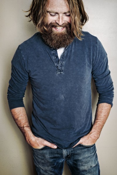 Caucasian man standing with hands in pockets
