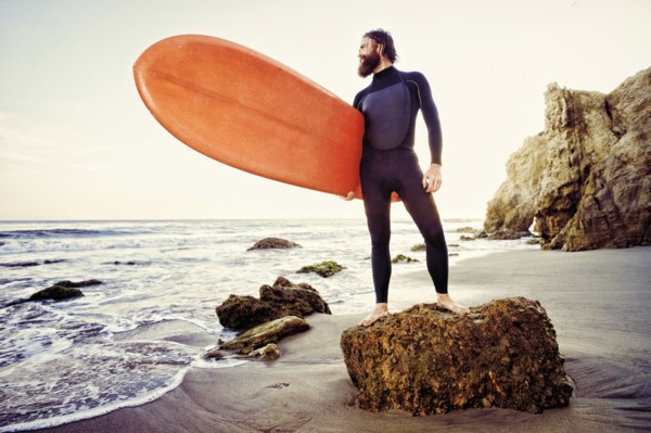Caucasian man holding surfboard at beach