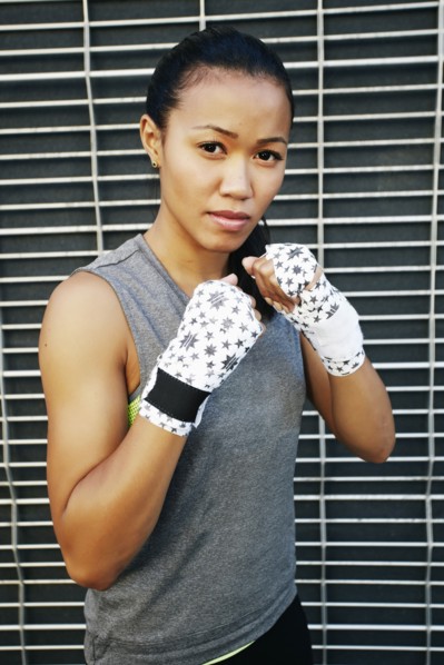 Mixed race athlete with raised fists