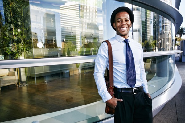 Black businessman smiling outside office building